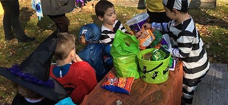 Children in costumes collecting candy