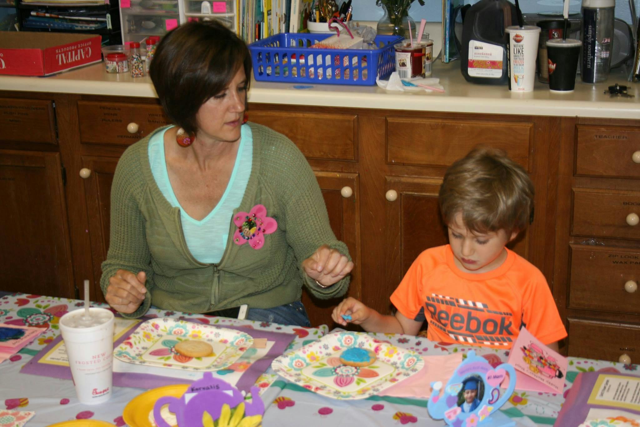 Person and child at a table with decorated plates