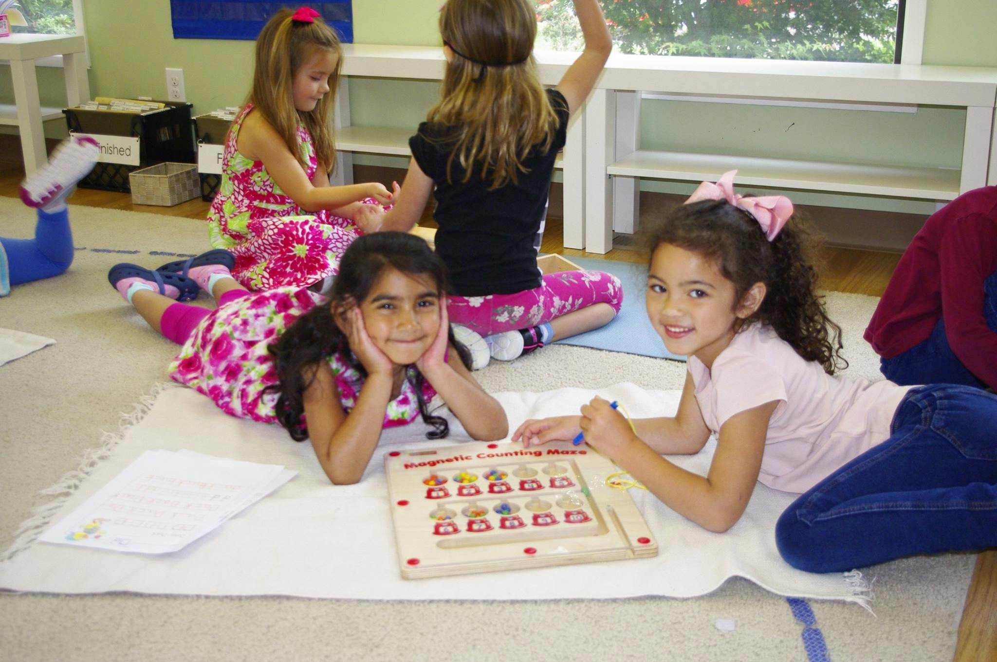 Children on floor with board game in classroom