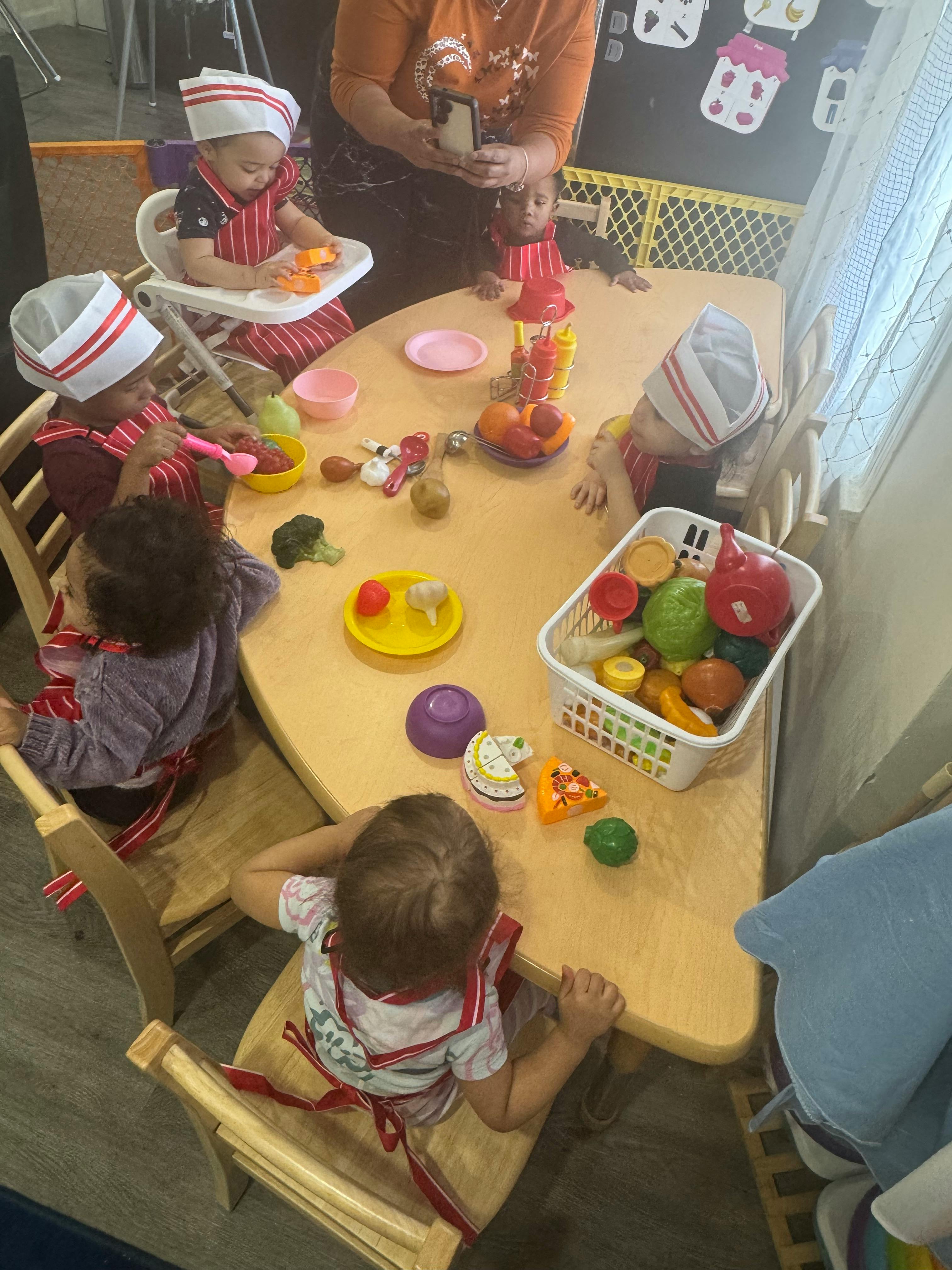 Children playing with toy food at a table