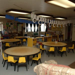 Classroom with round tables and yellow chairs