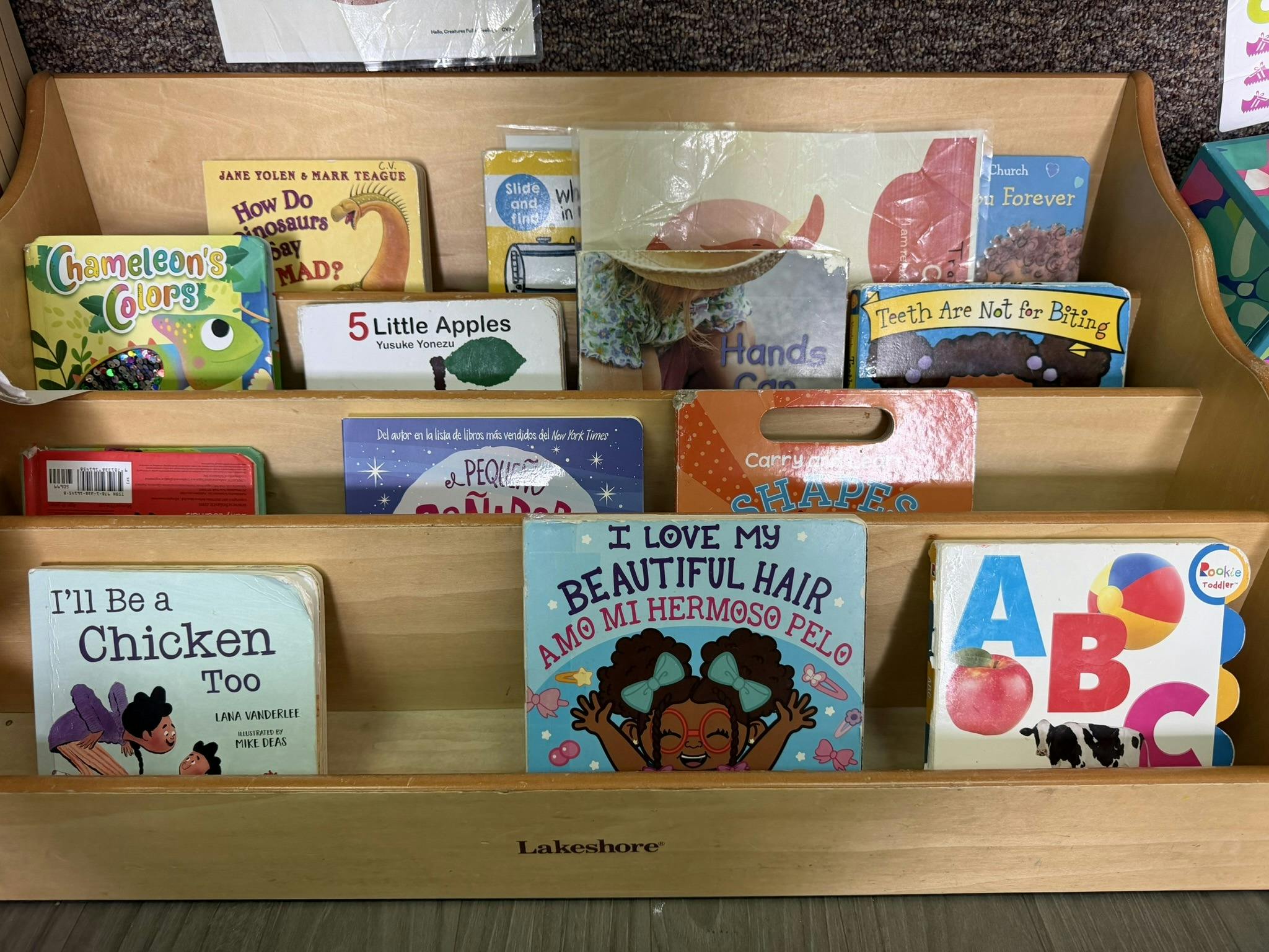 Children's books displayed on a wooden shelf