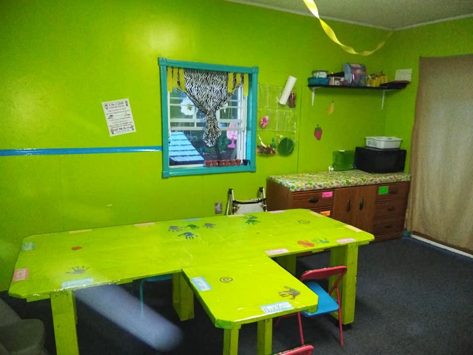 L-shaped table and chairs in a room with bright green walls