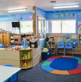 Preschool classroom with colorful rug and toys