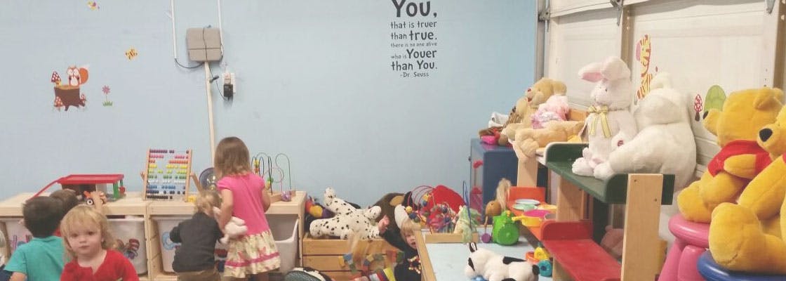 Children playing in a room filled with toys