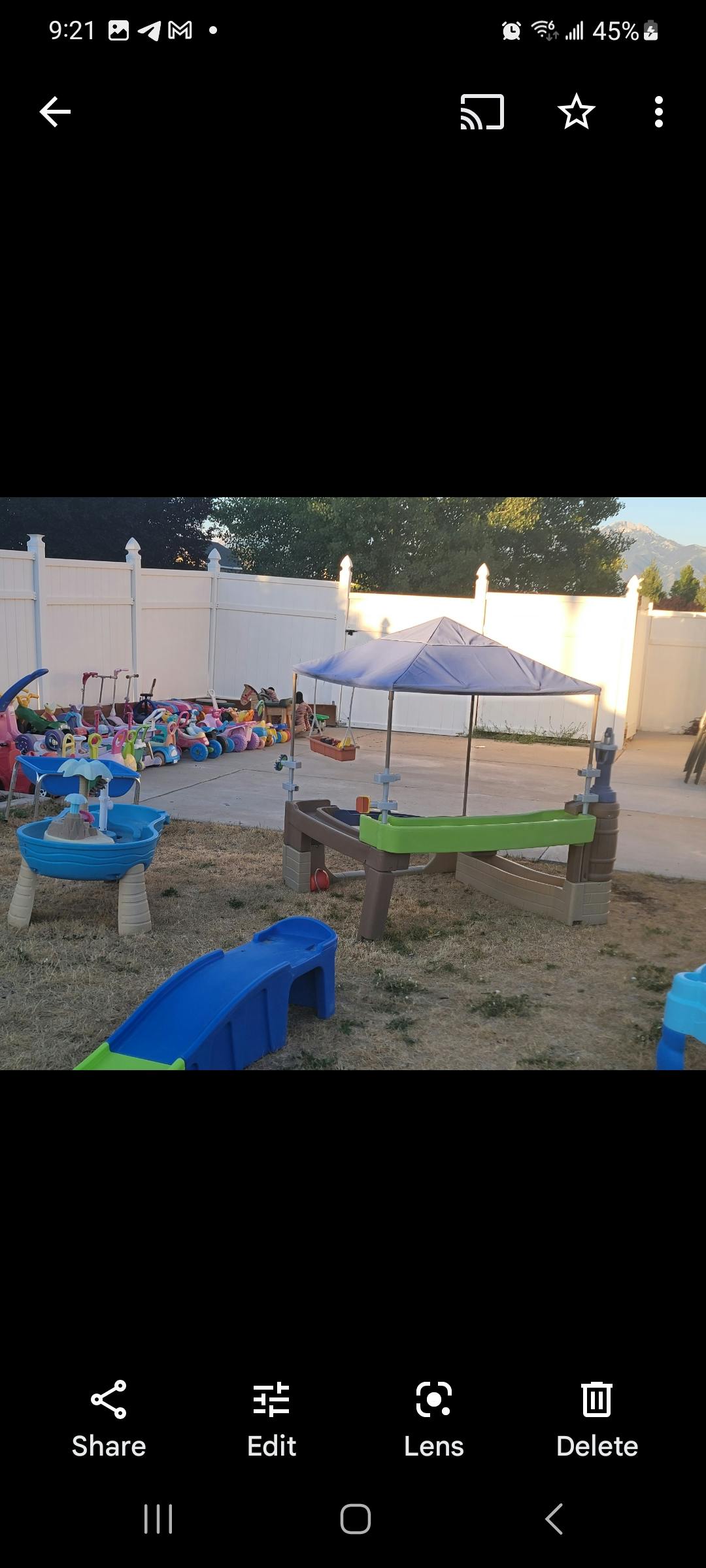 Outdoor play area with water tables, slides, and toys