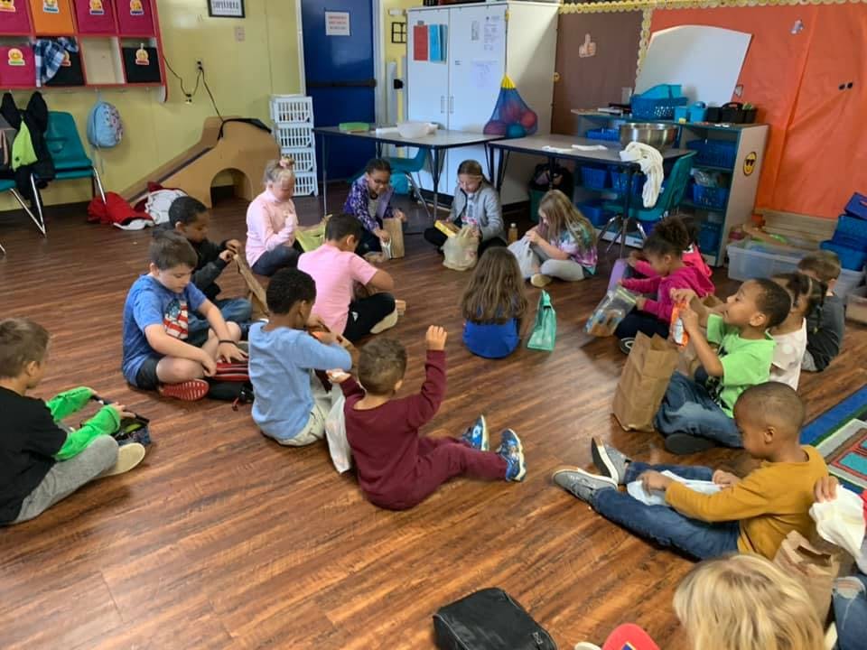 Children sitting on the floor in a classroom