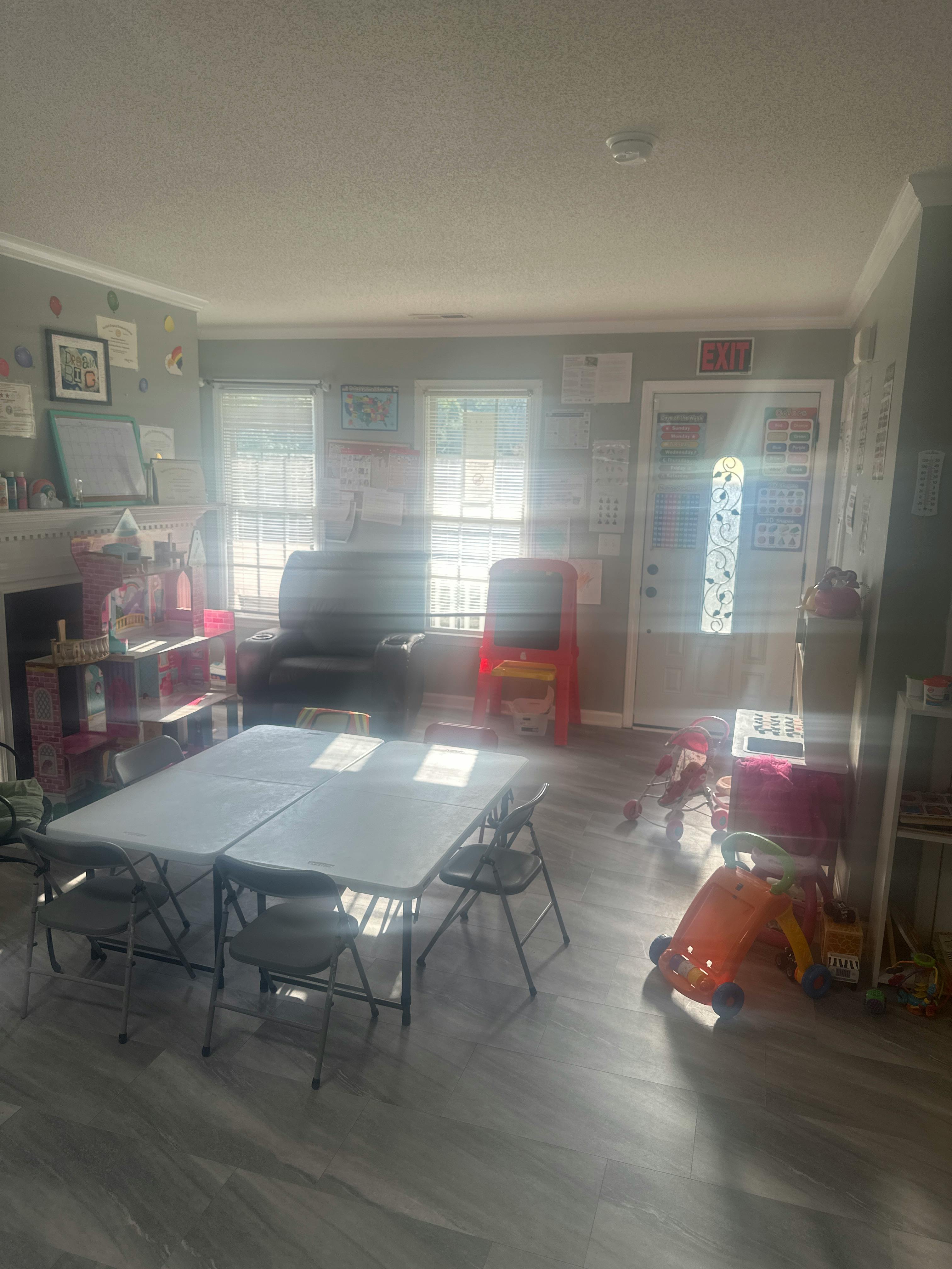 Two folding tables with chairs in a room with windows and furniture