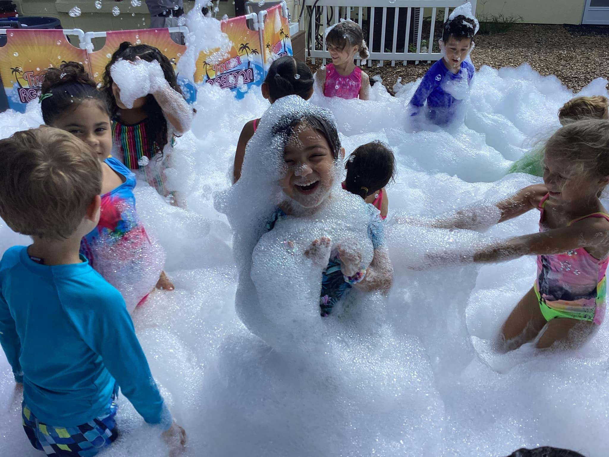 Children playing in a large pile of foam