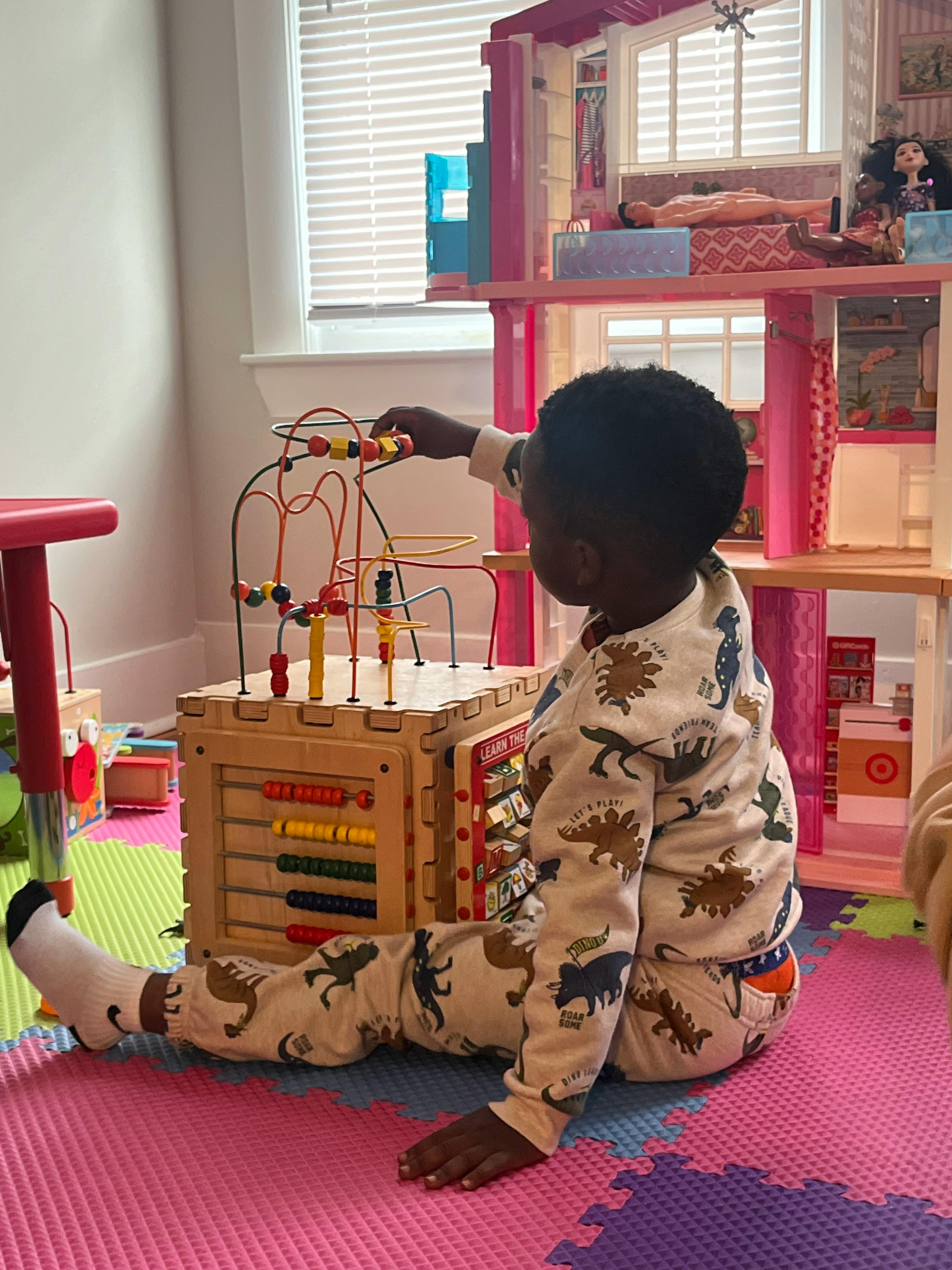 Child playing with a bead maze toy