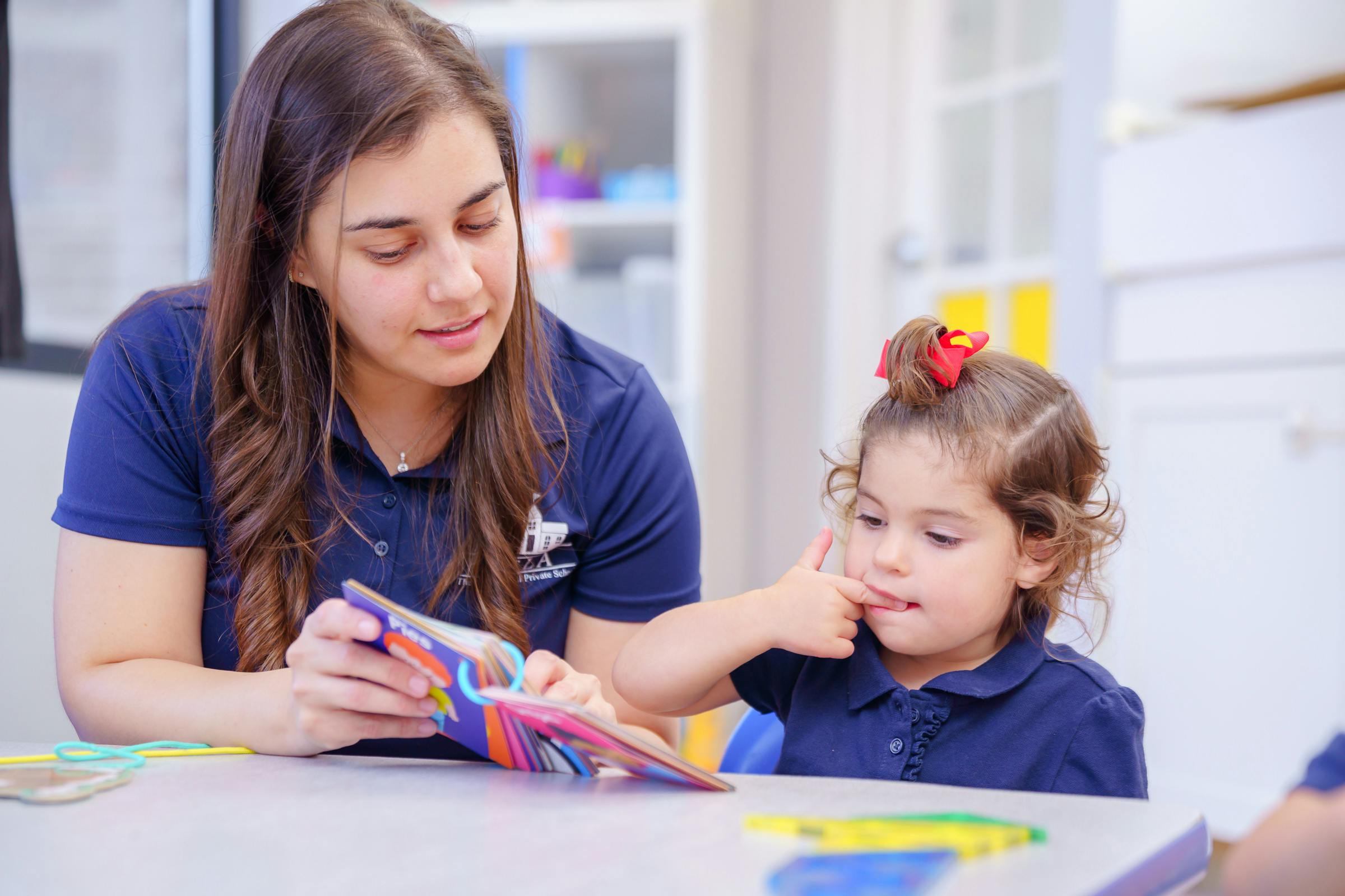 Person and child looking at a colorful book