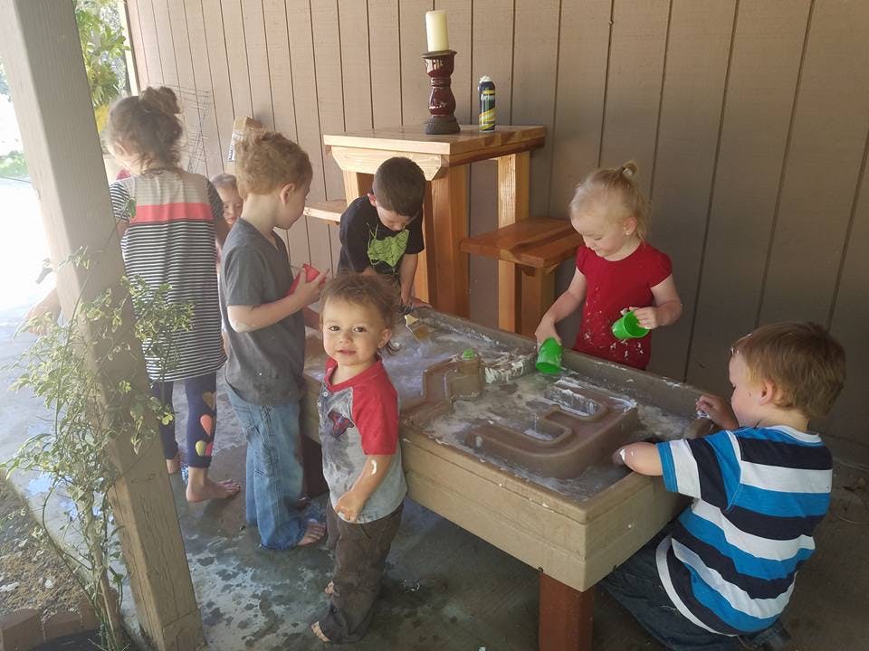 Children playing at a water table