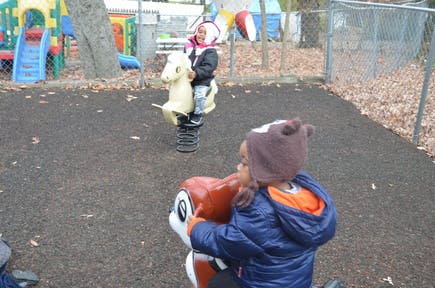 Two children on spring riders on a playground