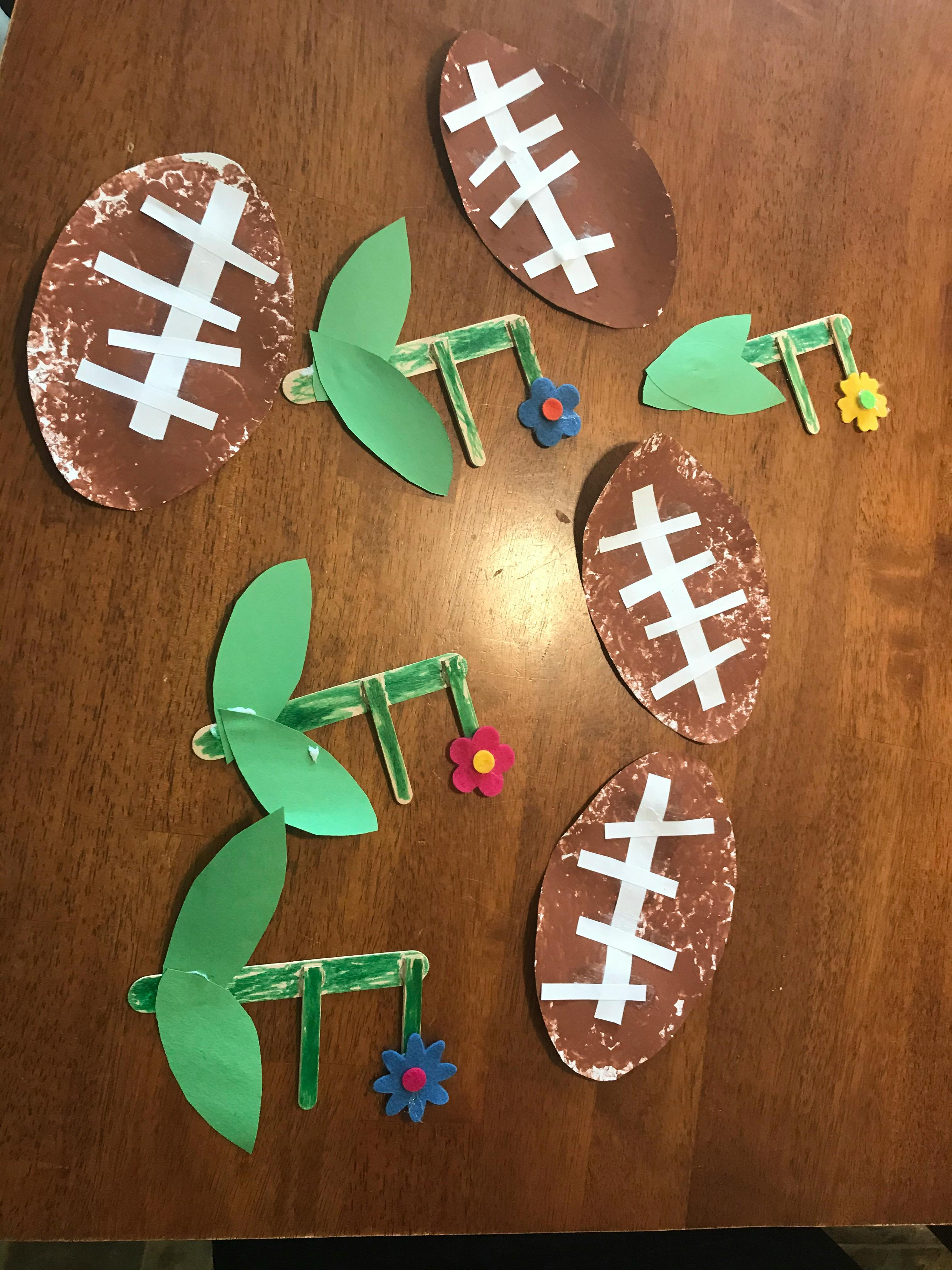 Crafts of footballs and green insects with flowers