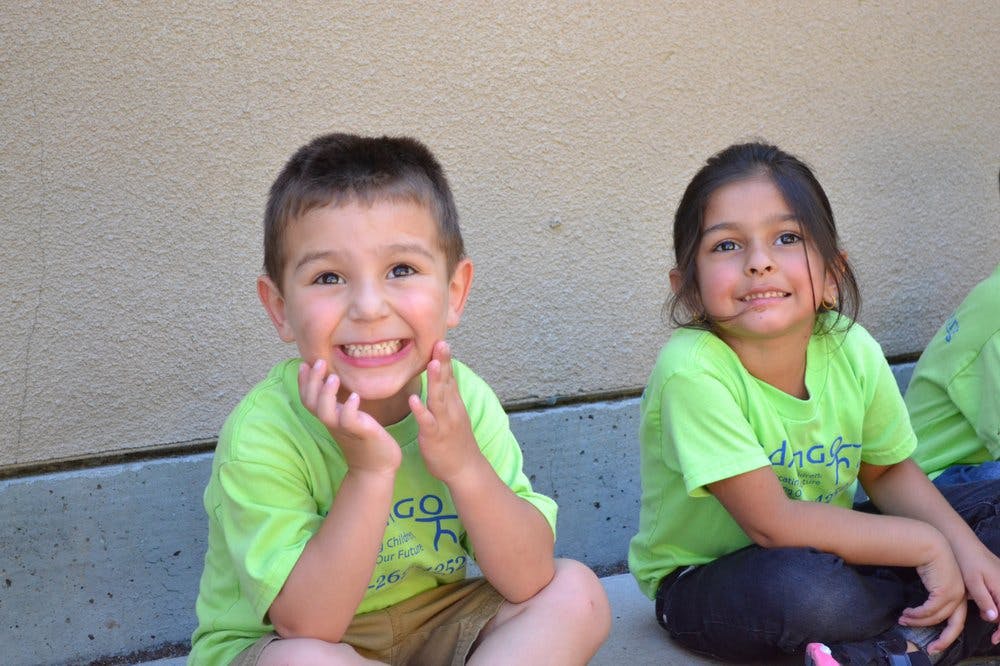 Two children sitting on the ground