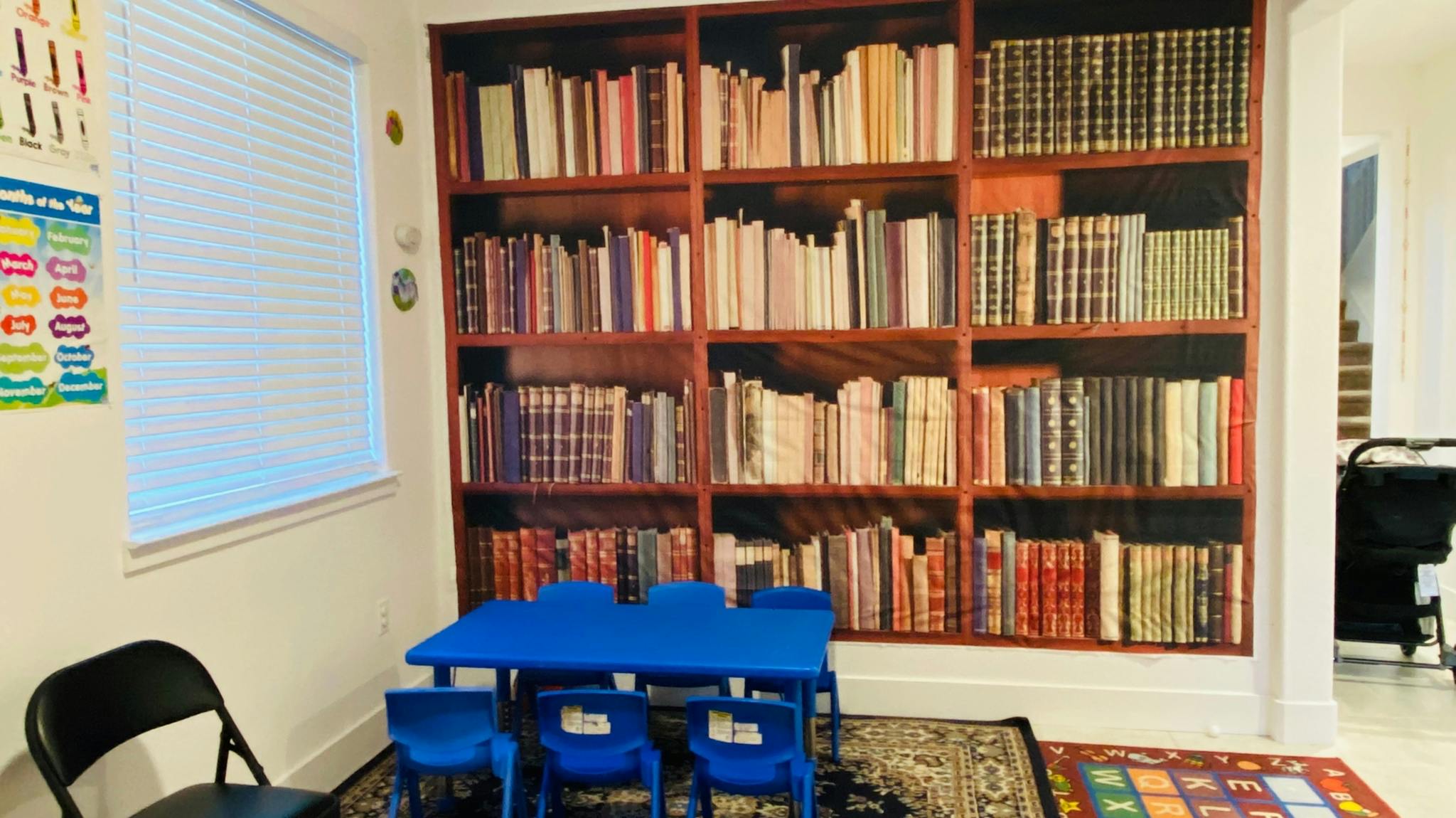 Children's table and chairs in front of a bookshelf wall