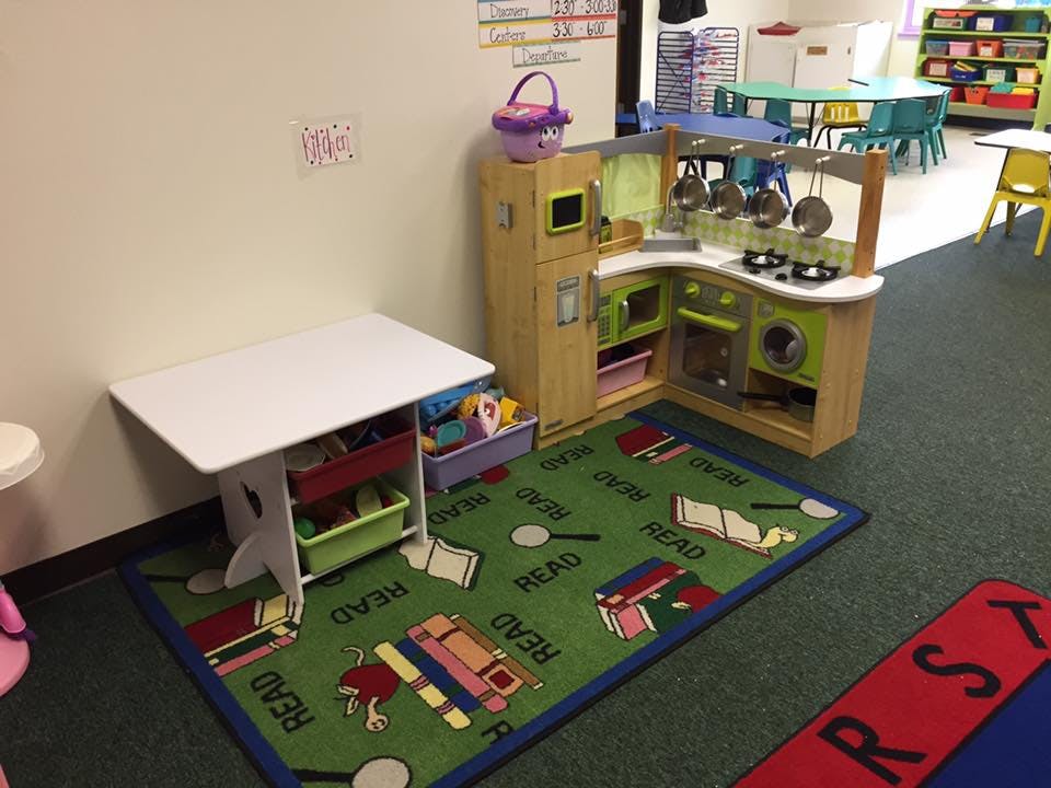 Play kitchen and small table with storage in a classroom