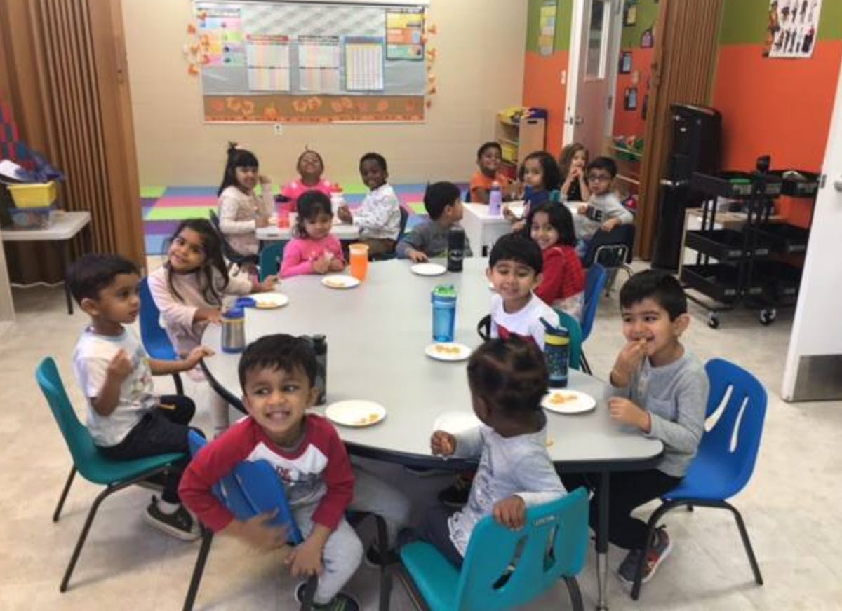Group of children sitting around a table in a classroom