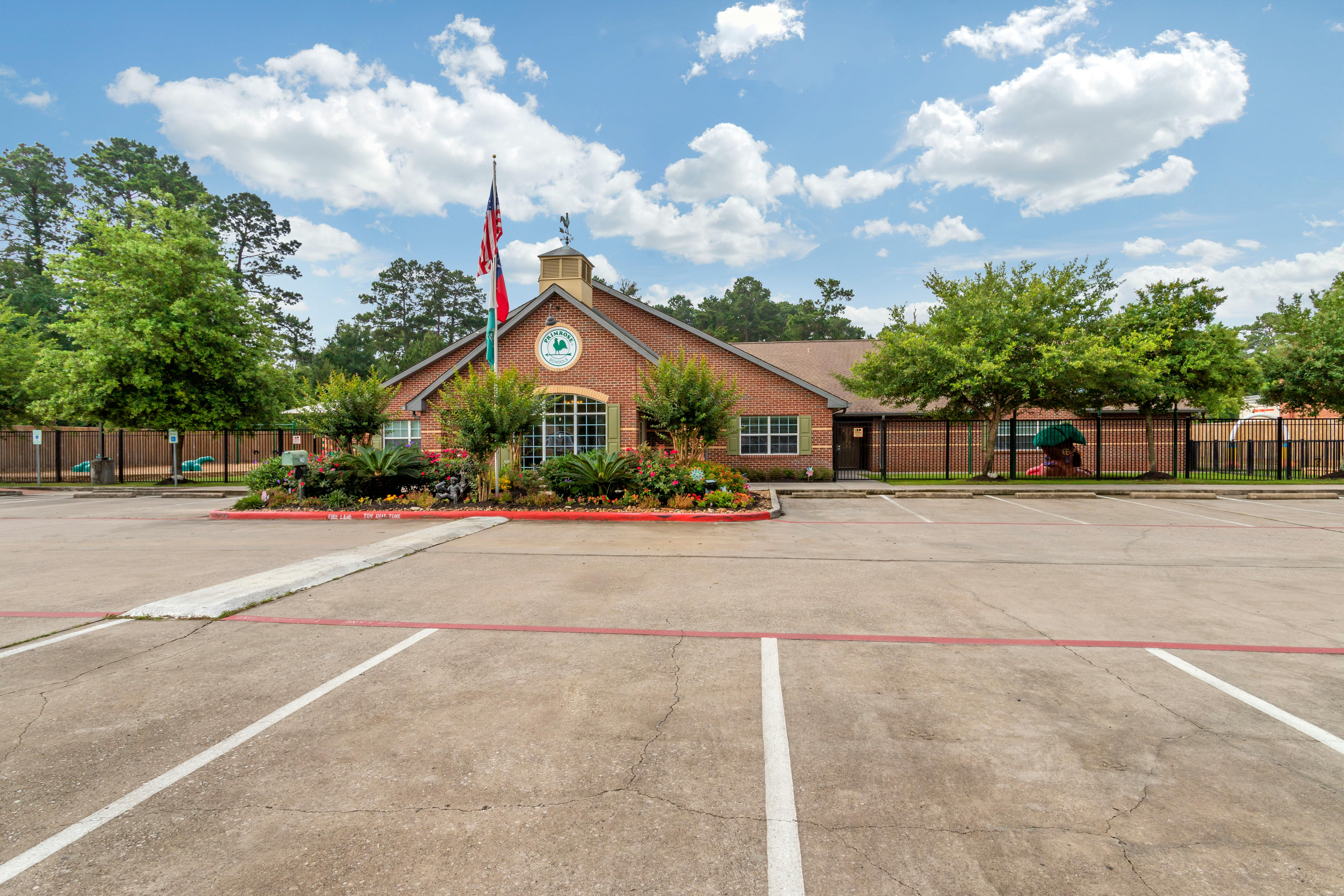 Brick school building with an American flag and a logo that says "Primrose School"