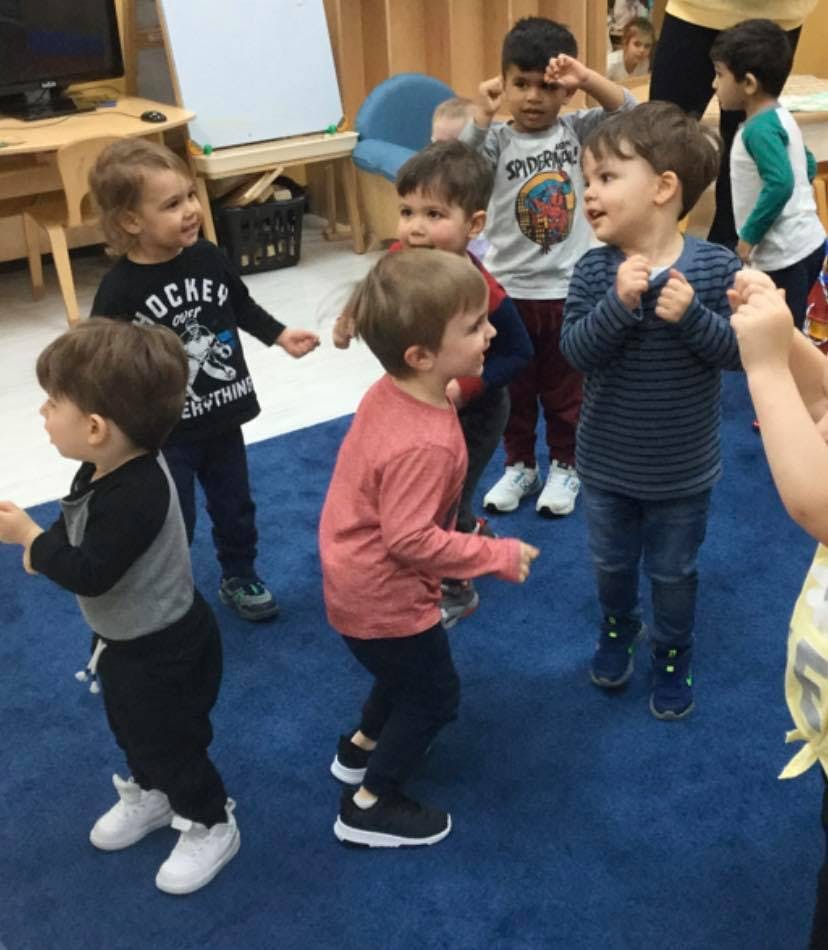 Group of children standing in a classroom
