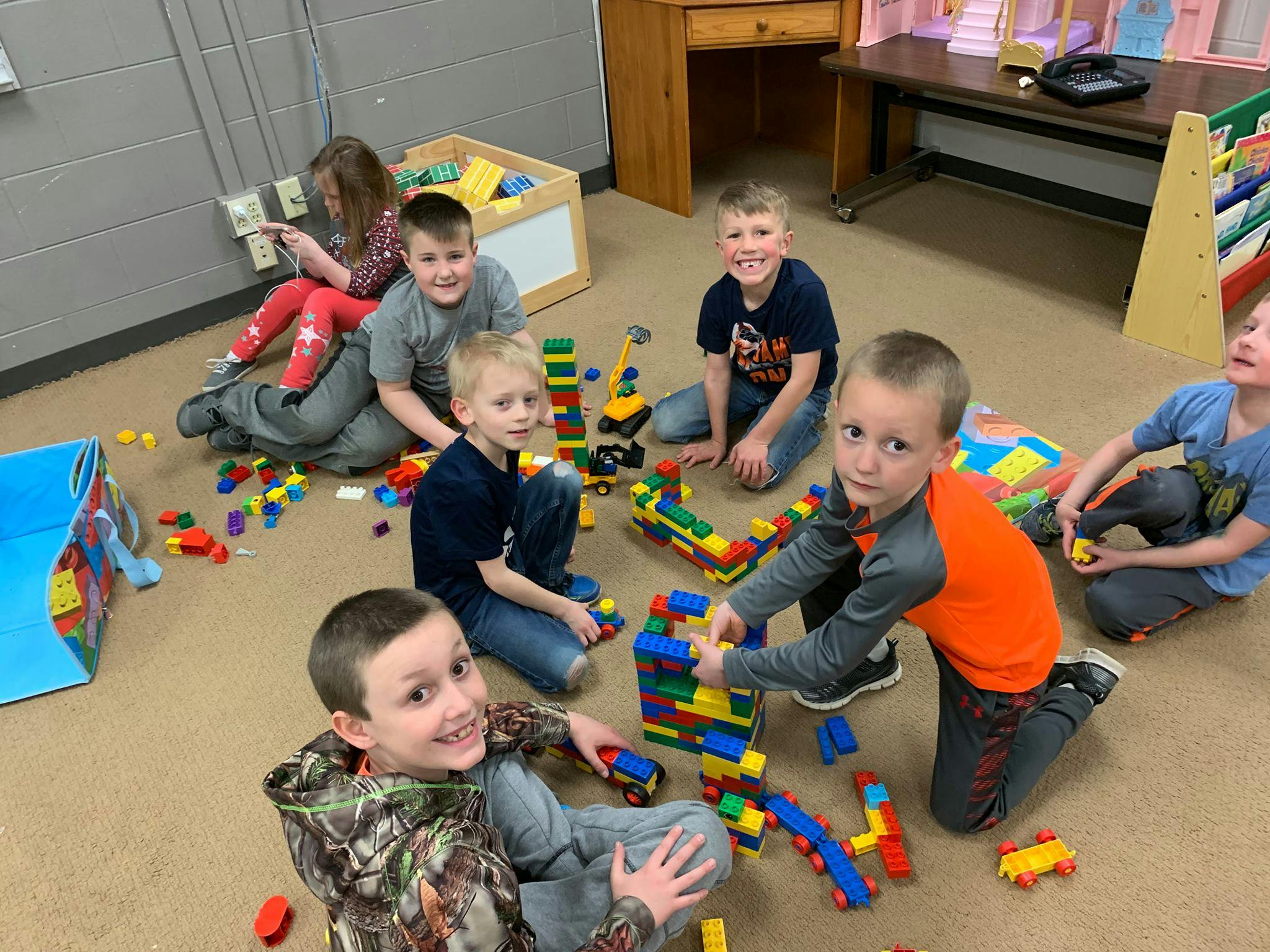 Children playing with building blocks on the floor