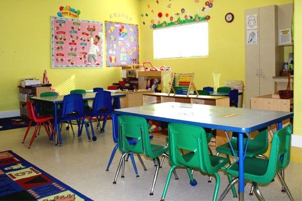Empty classroom with small tables and chairs
