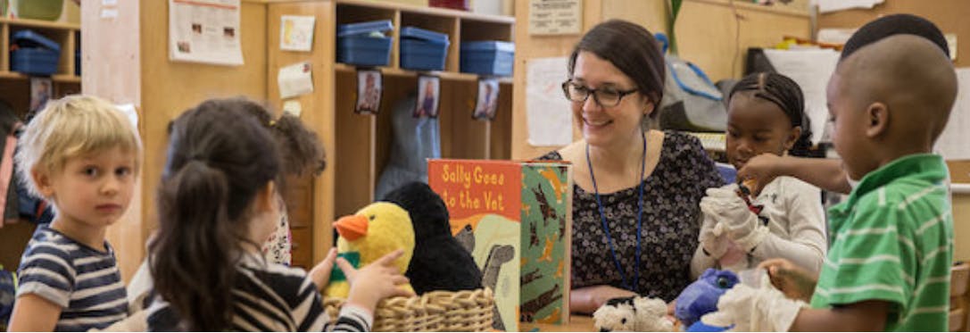 Adult and children interacting in a classroom