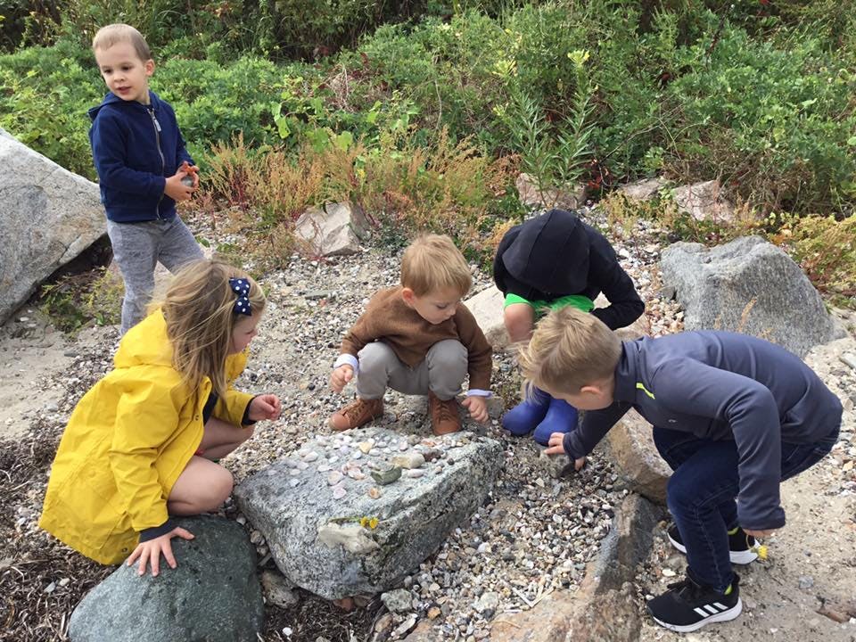 Children looking at rocks and pebbles on the ground