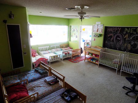 Room with multiple cribs and toddler beds