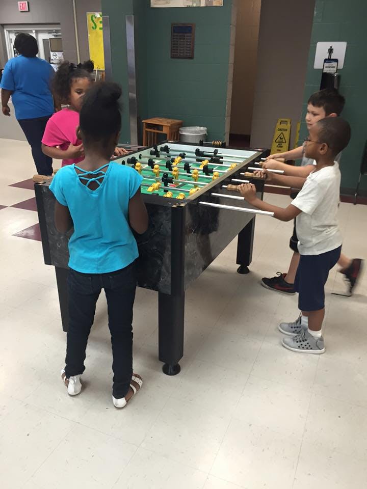 Children playing foosball