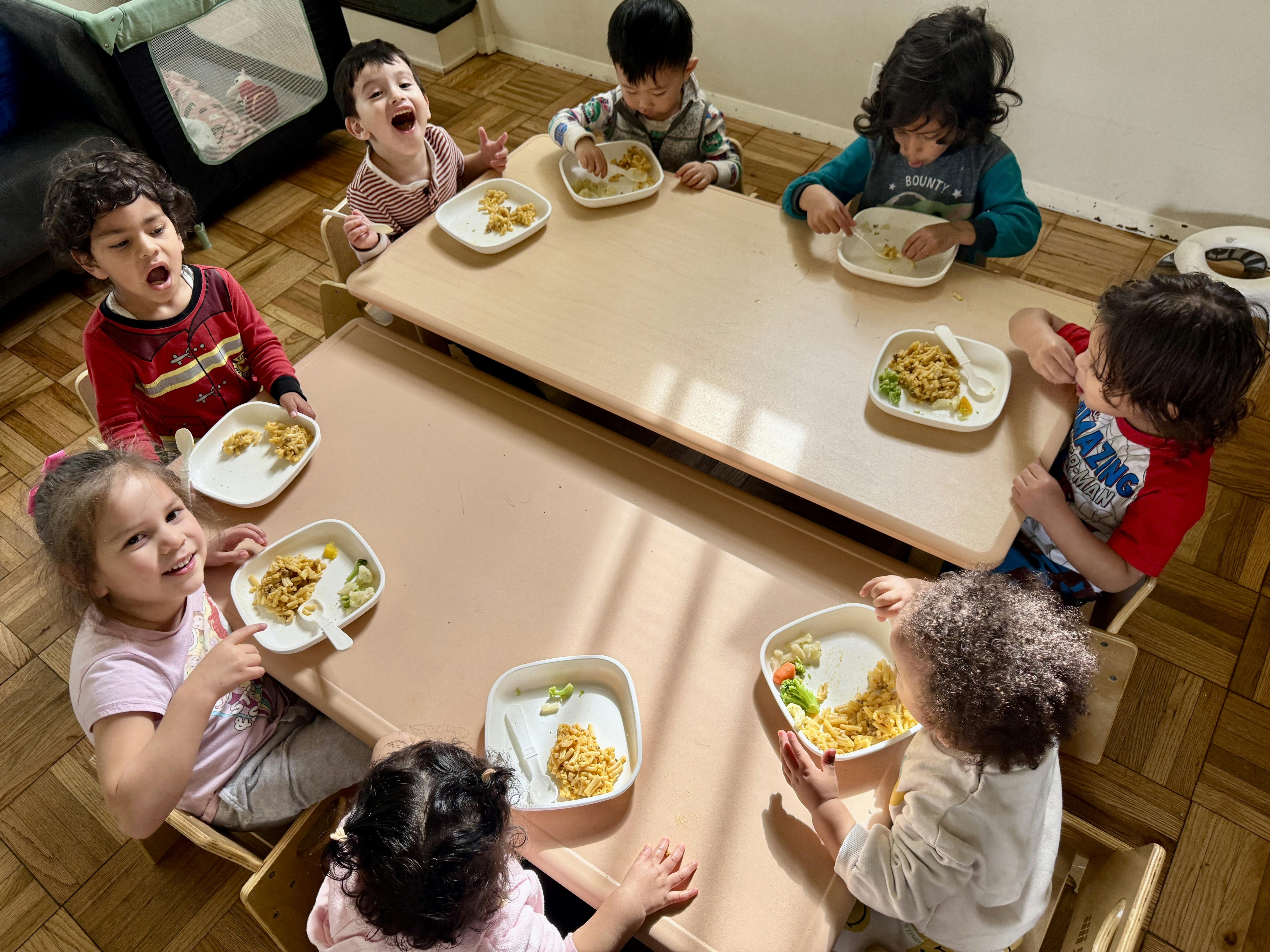 Children eating at tables in a classroom