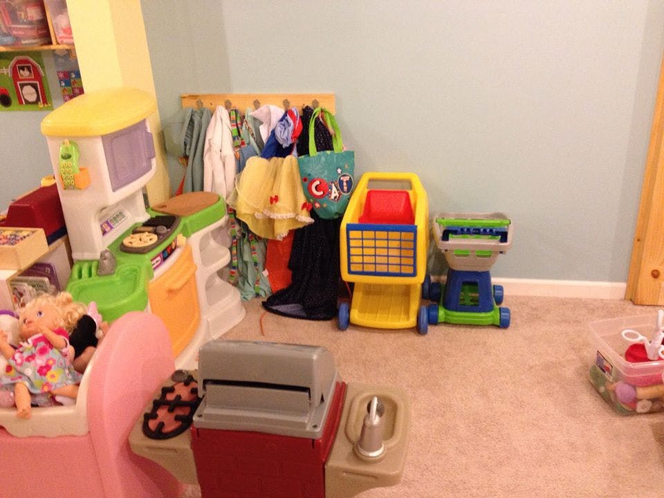Children's play kitchen, shopping cart, and dress-up clothes