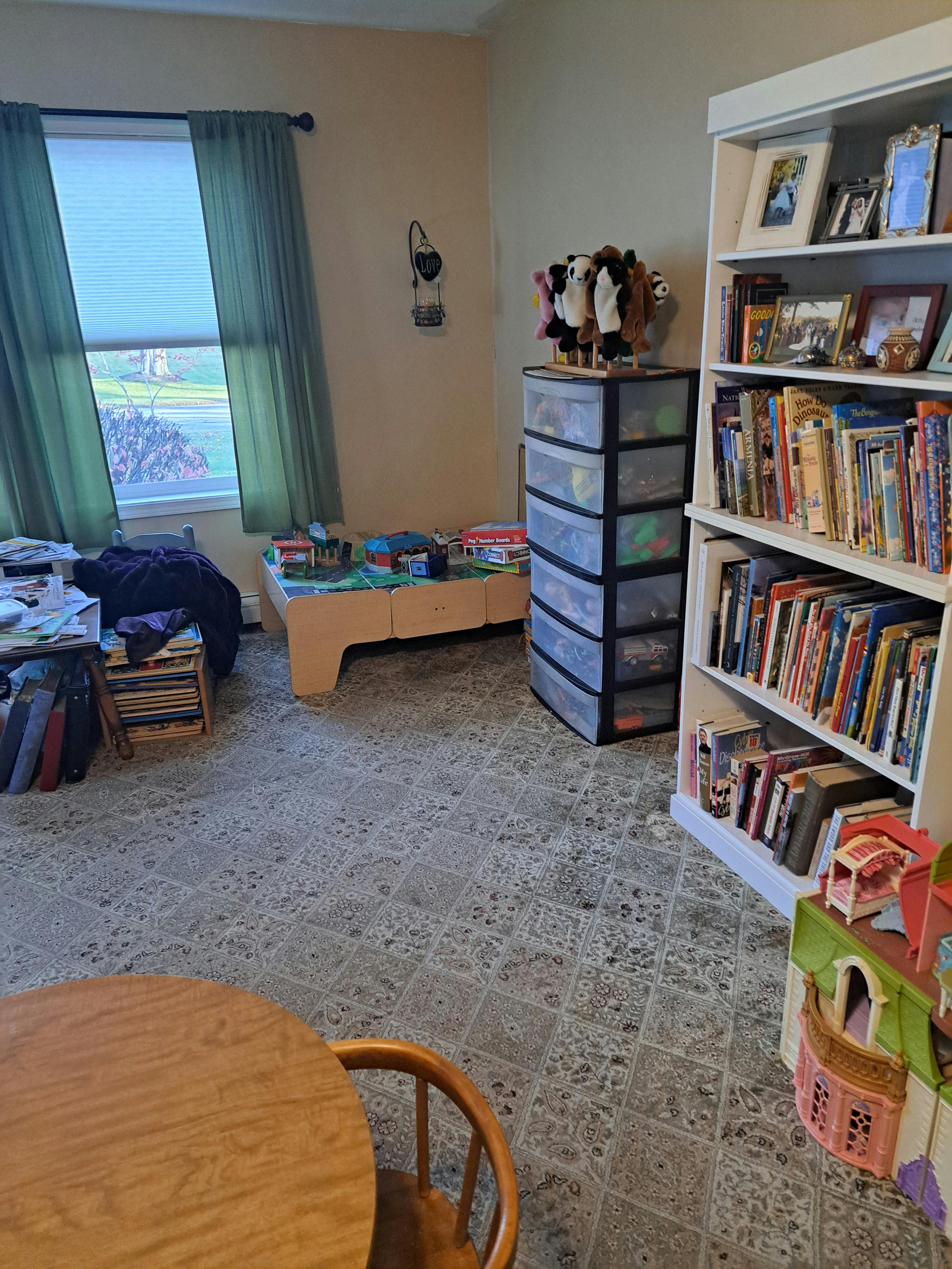 Room with a window, bookshelf, and storage drawers