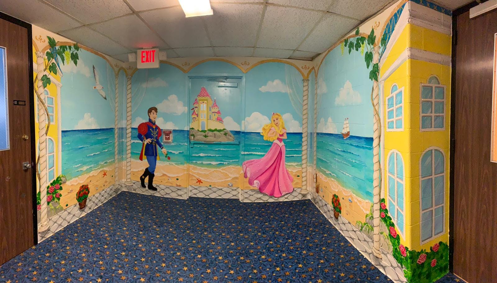 Hallway with a mural of a beach scene and cartoon characters