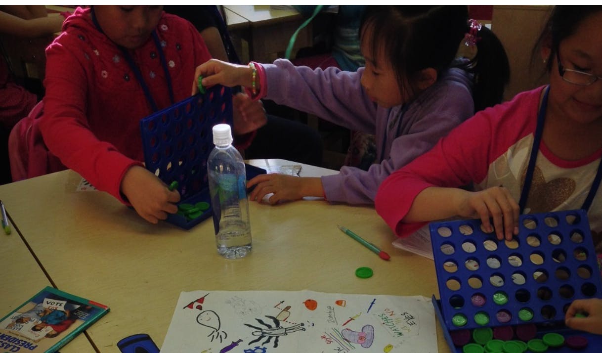 Children playing a board game at a table