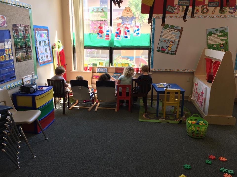 Children sitting at tables in a classroom