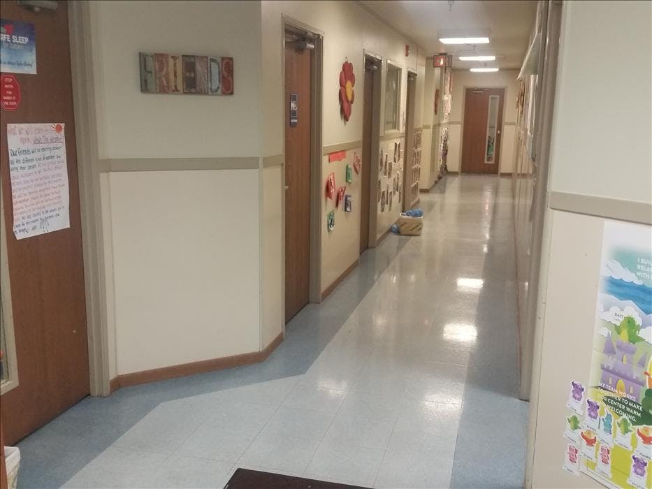 Hallway with doors, decorations on walls, and text "FRIENDS" above a doorway