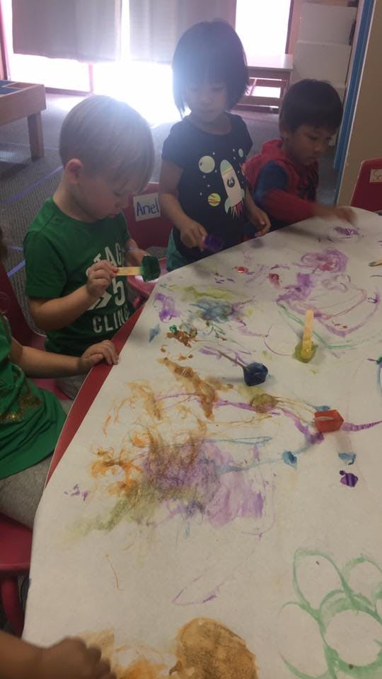 Children painting at a table