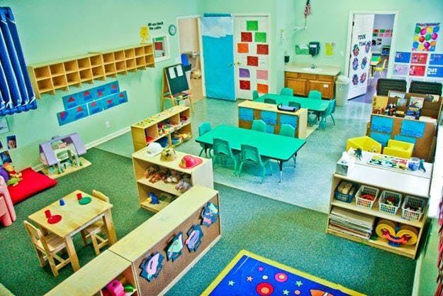 Empty classroom with small tables and chairs