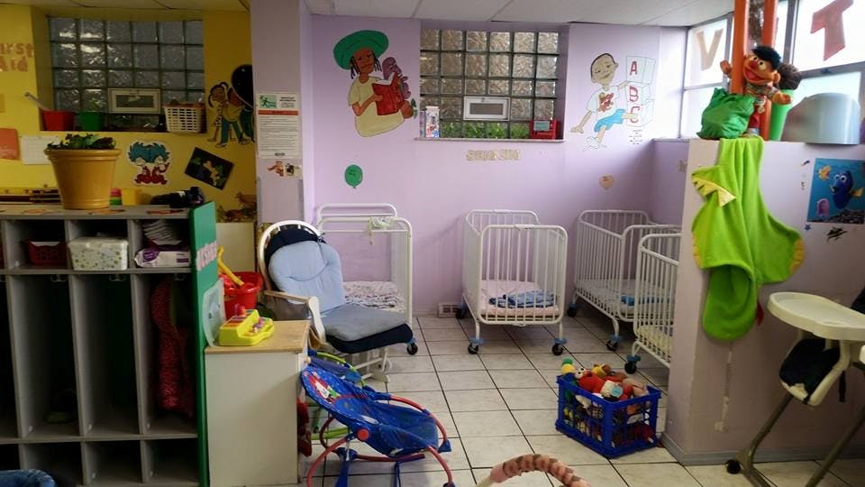 Nursery room with multiple cribs and child care items