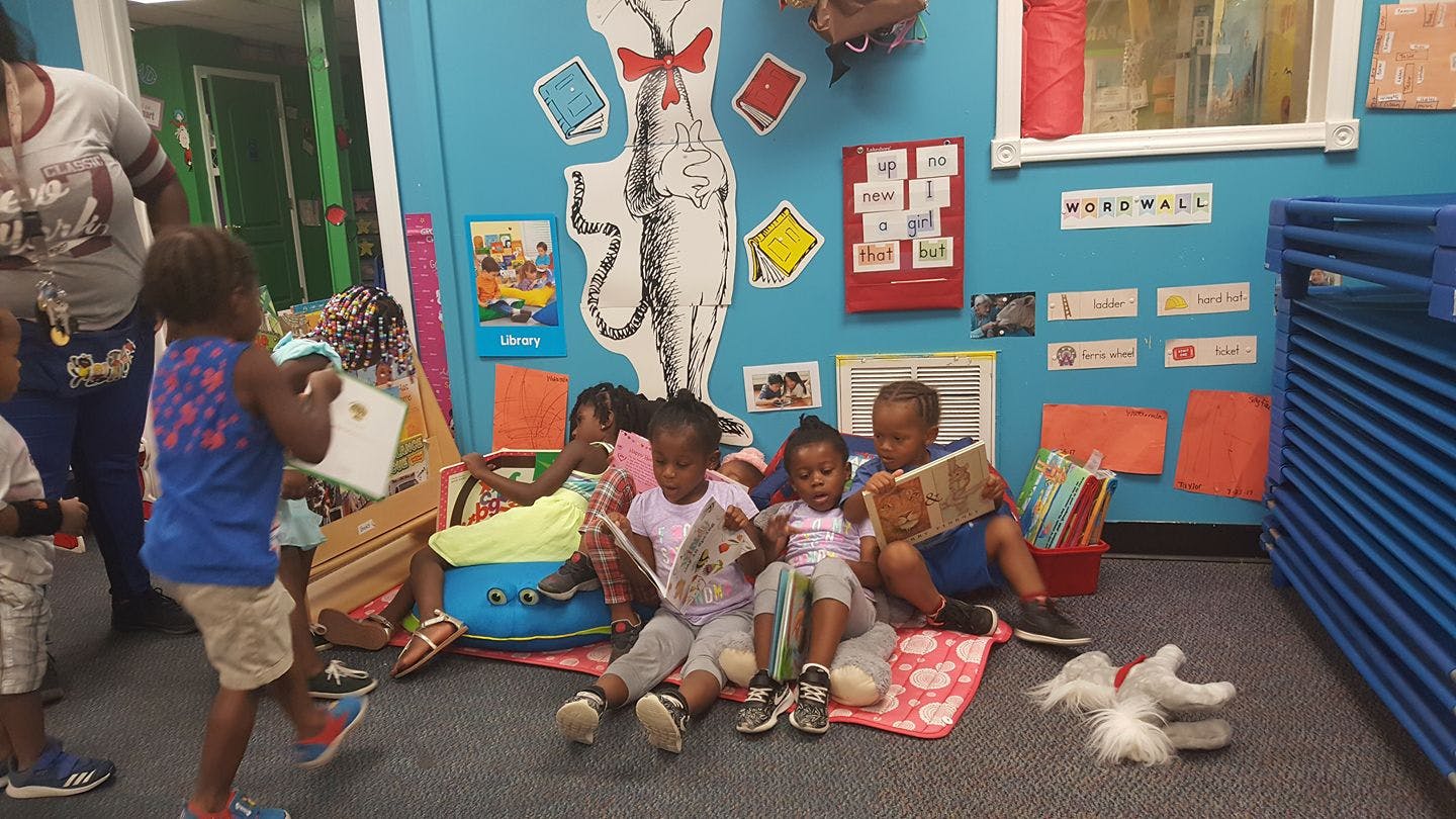 Children reading books in a classroom