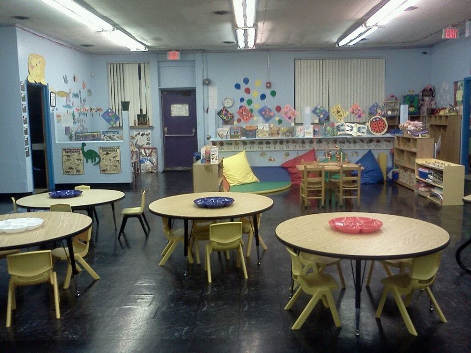 Empty classroom with small tables and chairs