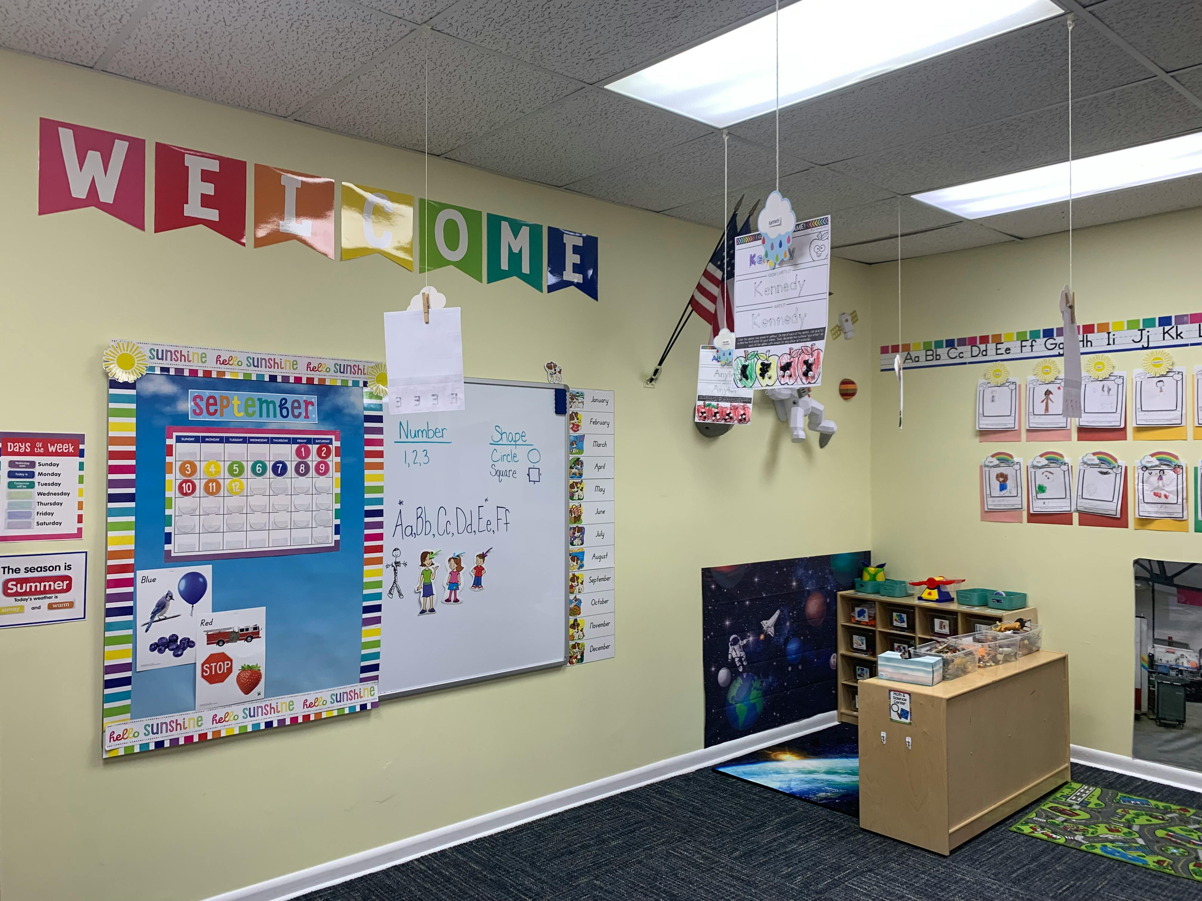Classroom with a welcome banner, bulletin board, and whiteboard