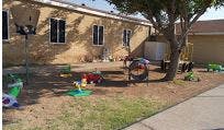 Playground with various toys and equipment in a yard