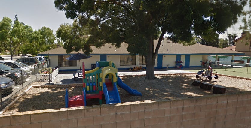 Playground with colorful play structure and building in background