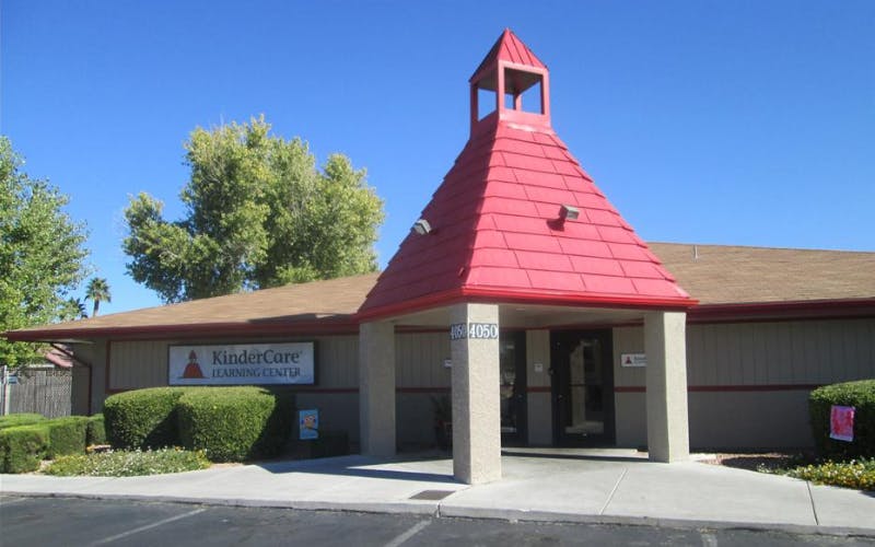 KinderCare Learning Center building with a prominent red roof and steeple