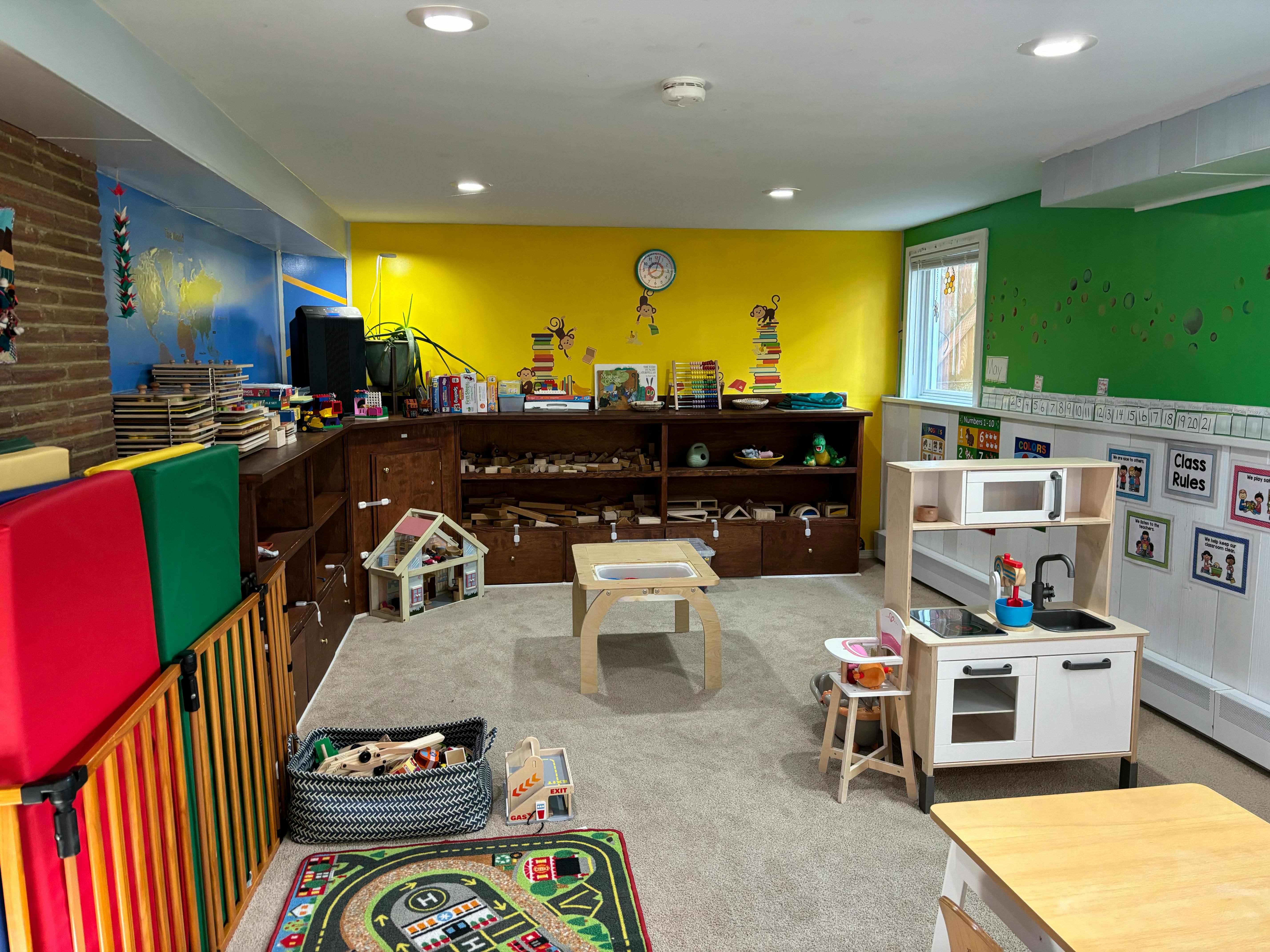 Playroom with colorful walls, shelves, and child-sized furniture