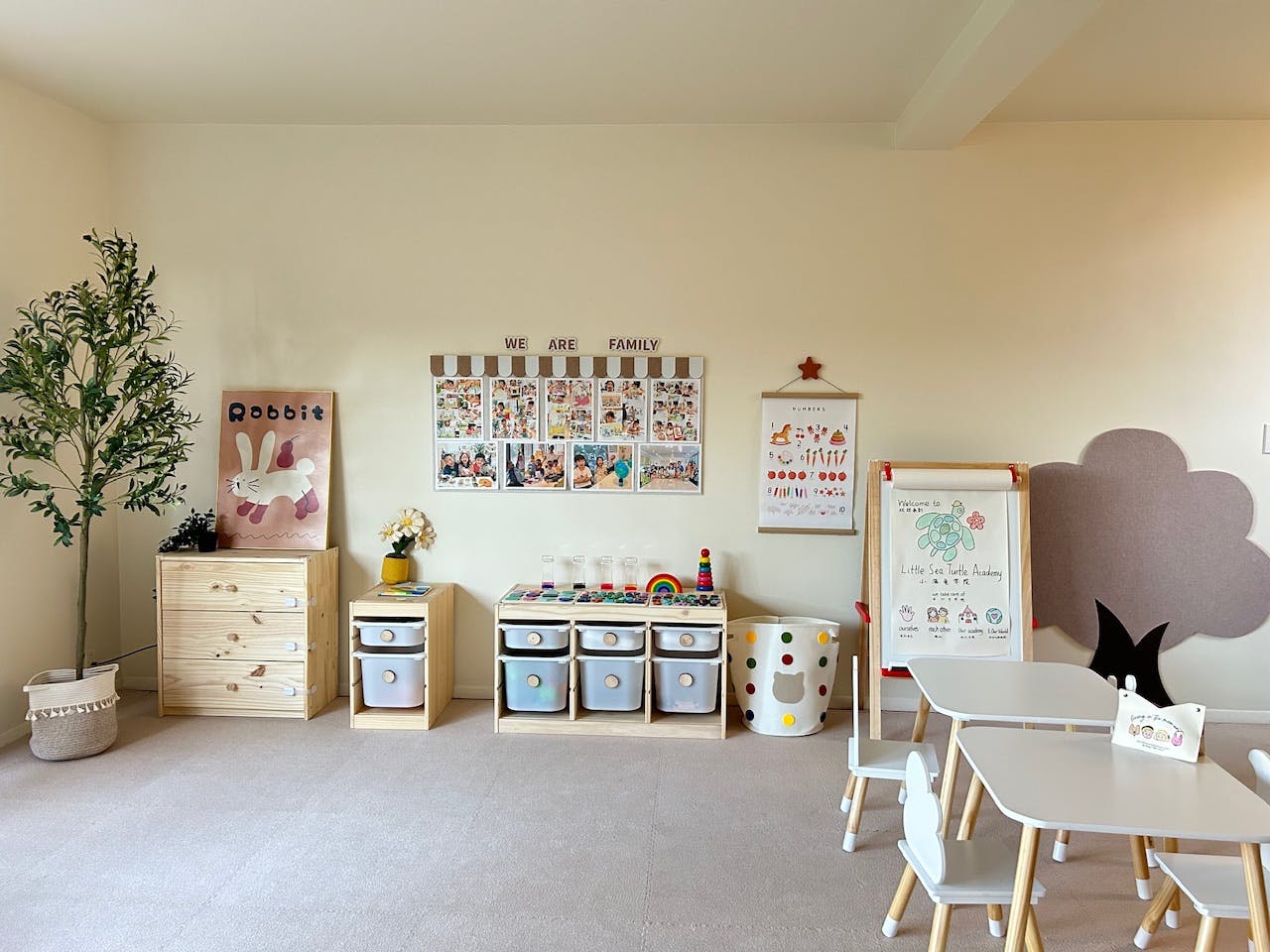 Classroom with small tables and chairs, storage units, and wall decorations