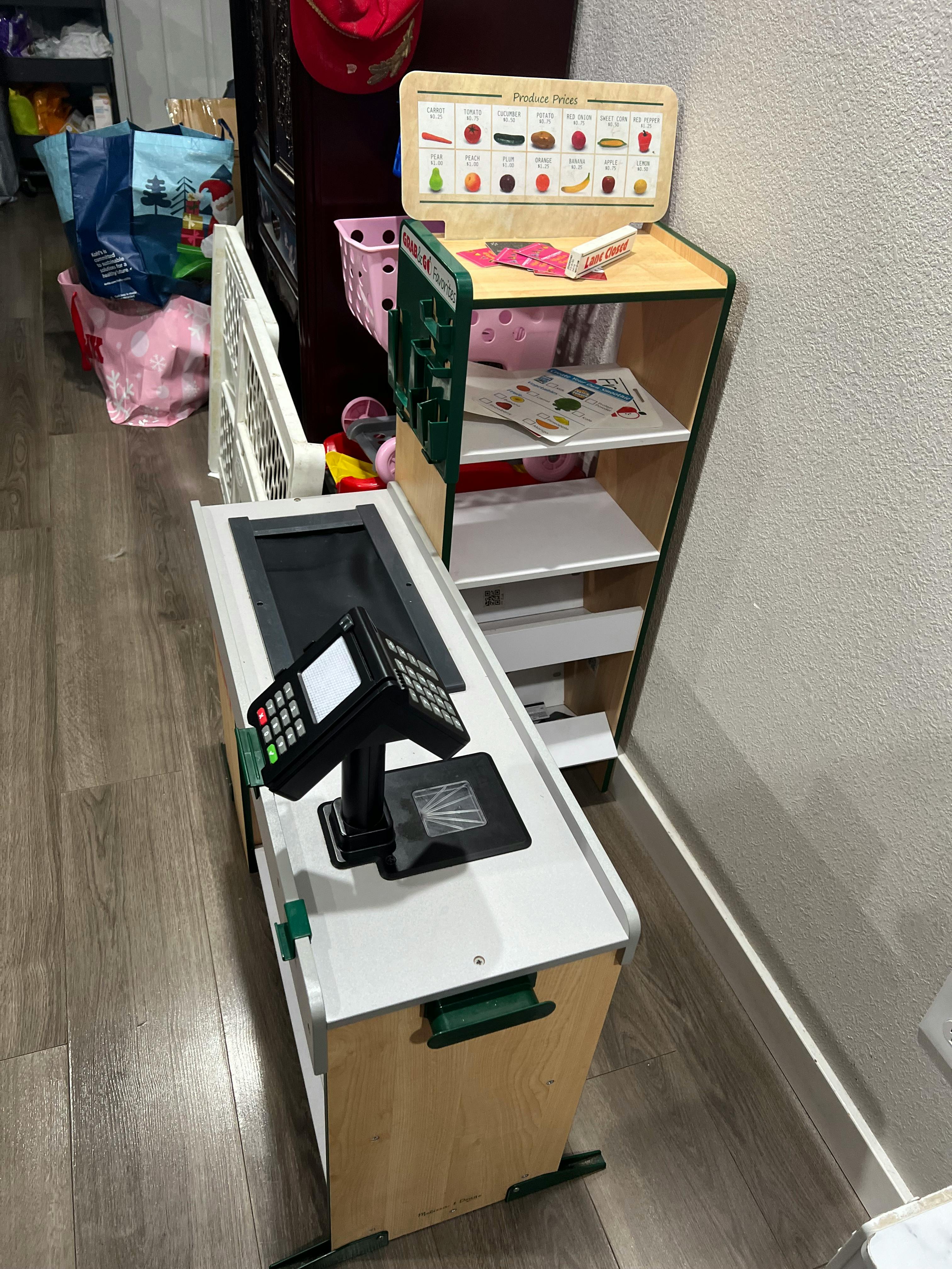 Toy grocery store checkout counter with a scanner and card reader