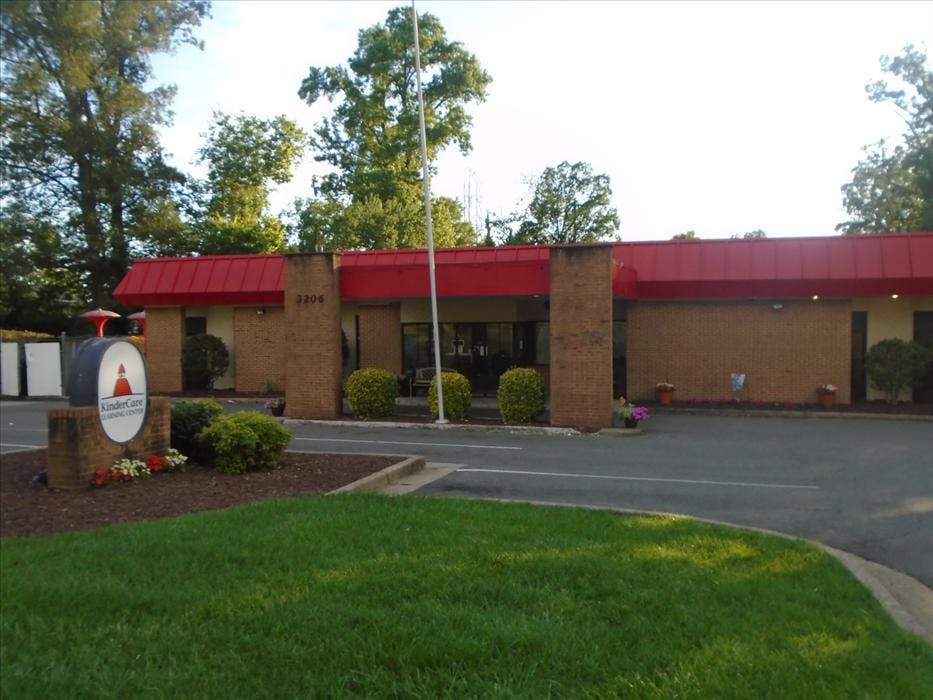 Brick building with a red roof and a KinderCare Learning Center sign